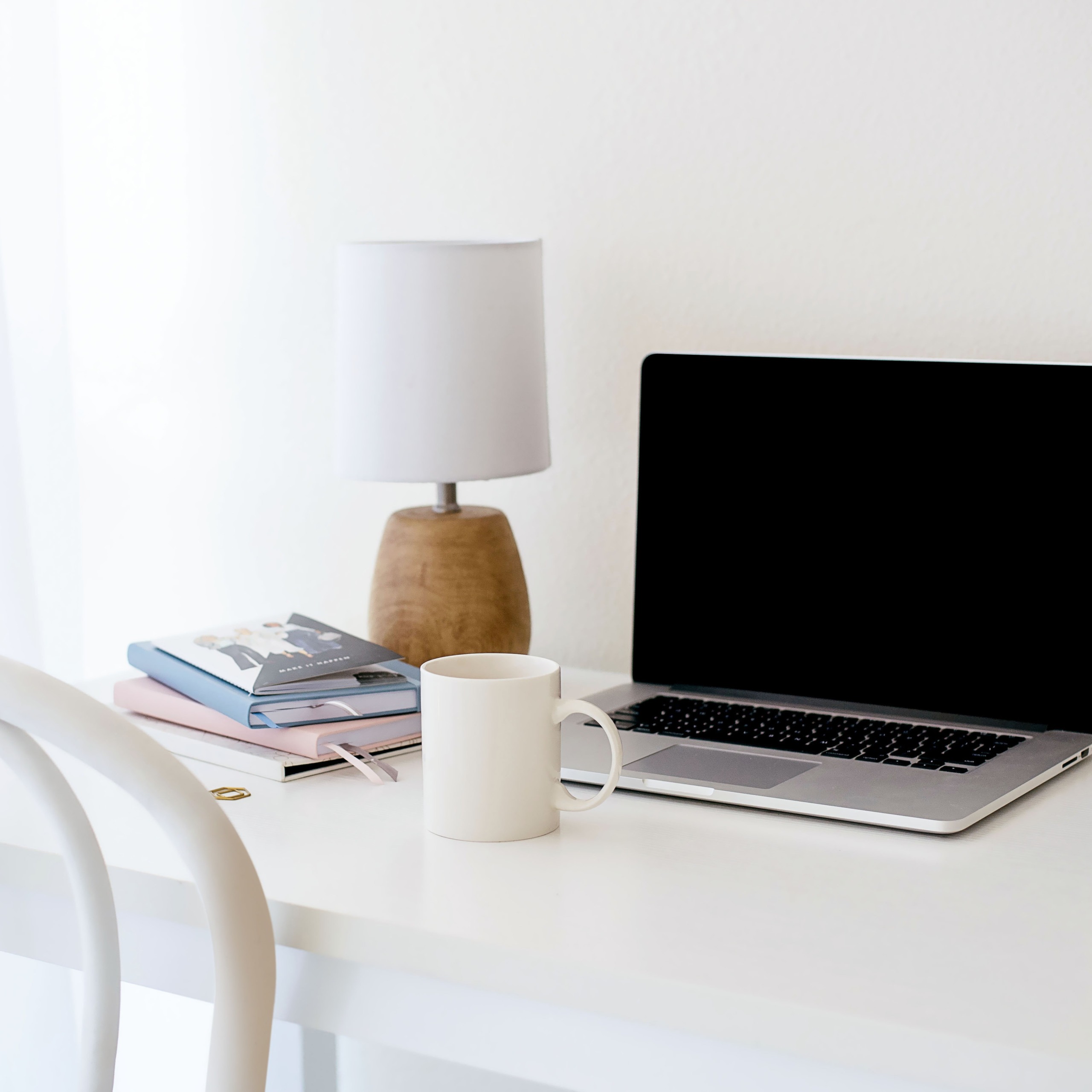 Laptop and coffee mug at minimalist work from home desk